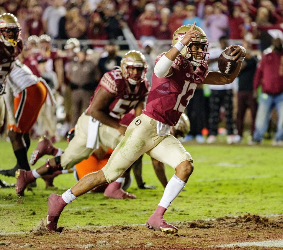 Florida State Seminoles quarterback Jordan Travis (13) scores on a two-point conversion. The Florida State Seminoles defeated the Miami Hurricanes 31-28 Saturday, Nov. 13, 2021.