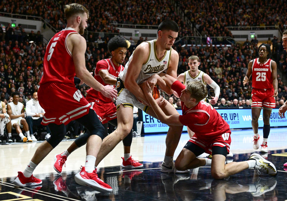 Purdue center Zach Edey (15) fights for a ball against Wisconsin forward Nolan Winter (31) during the second half of their game at Mackey Arena.