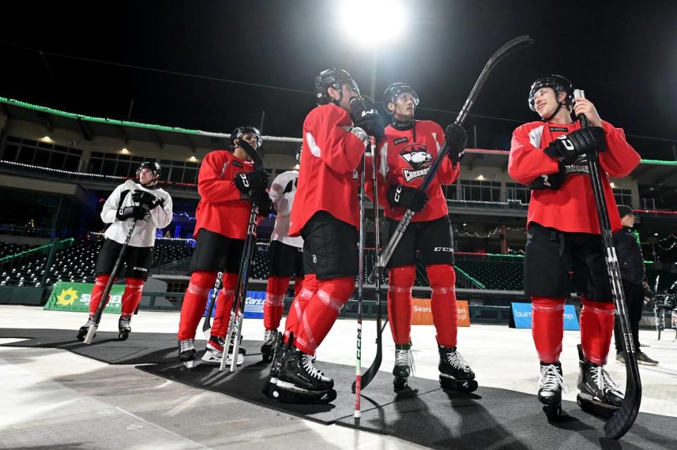 Members of the Charlotte Checkers stand off ice taking in the view of the skyline at Truist Field in Charlotte, NC on Monday, November 27, 2023. The Checkers will face the Americans in the Queen City Outdoor Classic at Truist Field on Saturday, January 13, 2024.