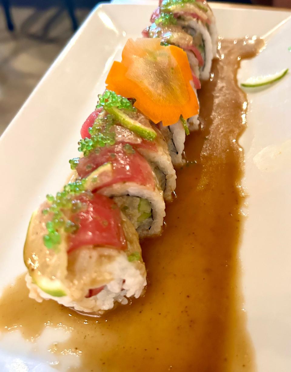 The Green Sky Roll is a Sushi Yuki specialty, featuring yellowtail, salmon, white tuna and tilapia, topped with green serrano pepper, lime, green tobiko (fly fish roe) and a basil ponzu sauce.