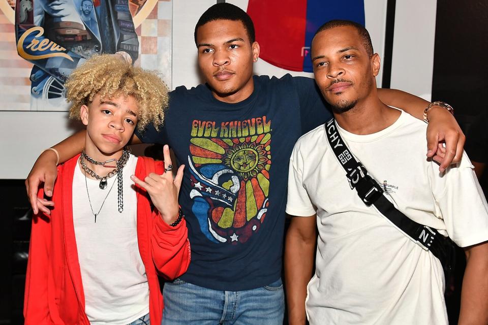 King Harris, Messiah Harris, and T.I. attend the Nipsey Hussle Exhibit Unveiling at The Trap Music Museum