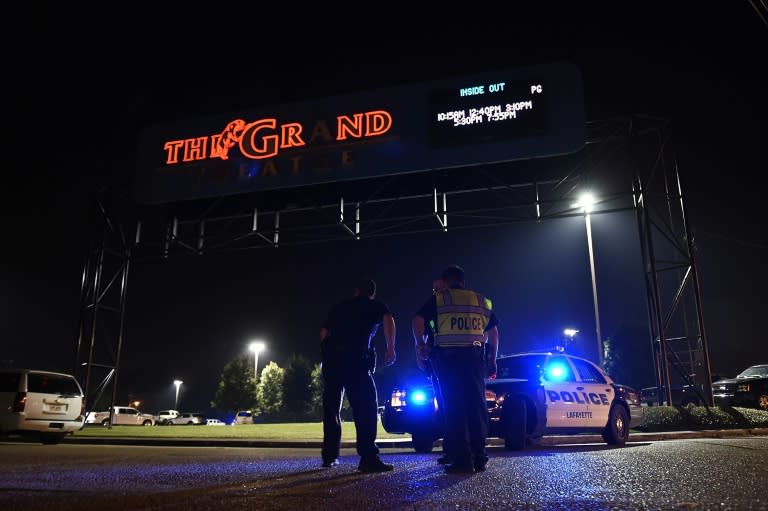 Lafayette police stand outside of the Grand Theater on July 23, 2015 in Lafayette, Louisiana, where a gunman opened fire