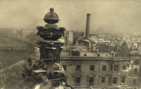 Russian soldiers are pictured on top of the Reichstag building in this undated photo taken May 1945 in Berlin. REUTERS/MHM/Georgiy Samsonov/Handout via Reuters