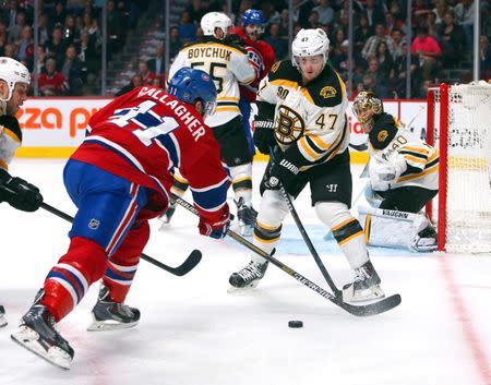 May 12, 2014; Montreal, Quebec, CAN; Montreal Canadiens right wing Brendan Gallagher (11) takes a shot on Boston Bruins goalie Tuukka Rask (40) and defenseman Torey Krug (47) during the third period in the game six of the second round of the 2014 Stanley Cup Playoffs at Bell Centre. Mandatory Credit: Jean-Yves Ahern-USA TODAY Sports