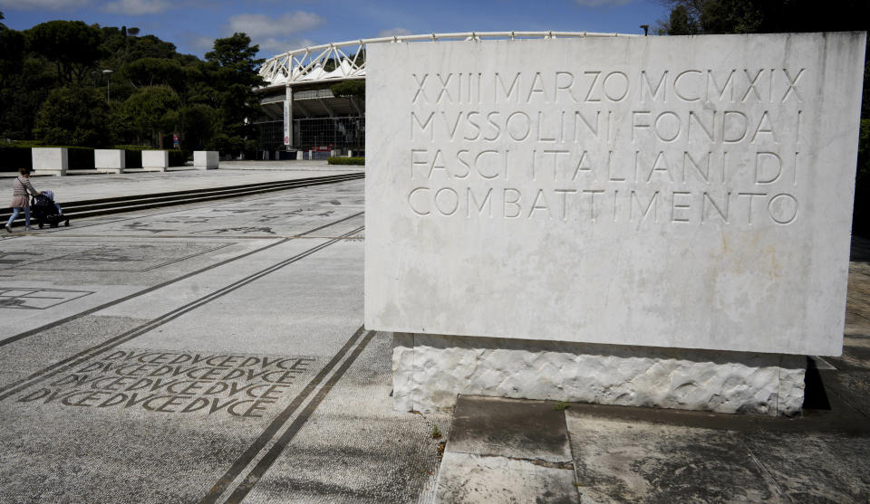 The word DVCE, which was Benito Mussolini's title, is written on the mosaic pavement of the The Piazzale at the Foro Italico sporting complex in Rome, Monday, May 6, 2019, next to a plaque commemorating the founding of Mussolini's Fasci Italiani di Combattimento (Italian Fighting Fasces) on March 23, 1919. The Foro Italico, formerly called Foro Mussolini (Mussolini's Forum) was built under Mussolini's regime to bolster Rome's bid for the Olympics in the 1940's. (AP Photo/Andrew Medichini)