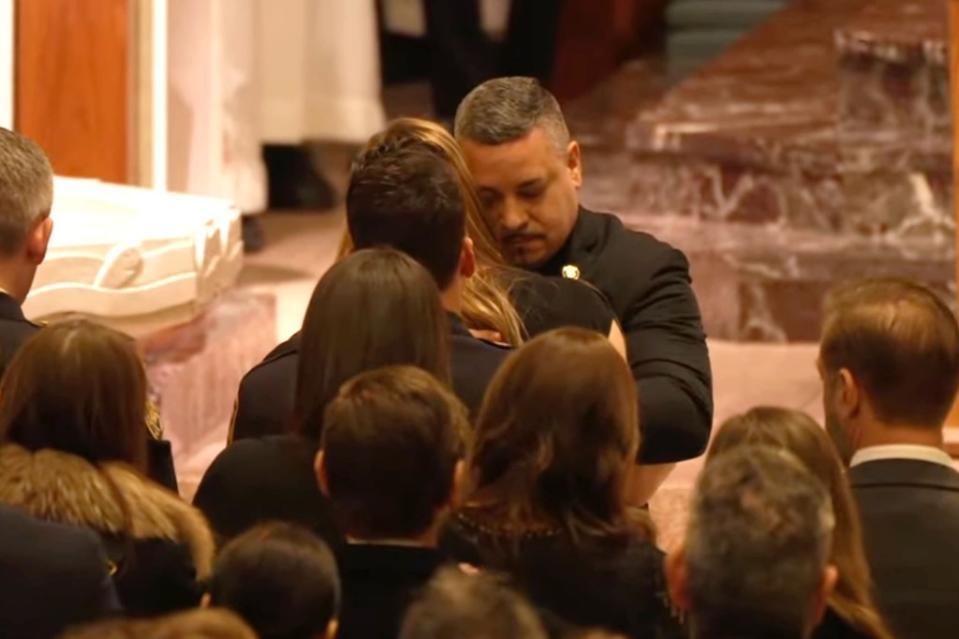 NYPD Commissioner Edward Caban comforting a mourner. NYPD