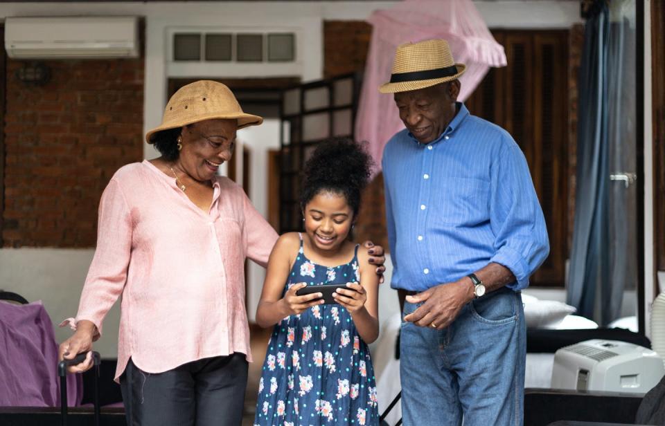 <span class="caption">Grandparents are eager to spend time with their grandchildren, and many are also eager to travel. There are many things to consider to ensure safety when going to hotels and overnight accommodations. </span> <span class="attribution"><a class="link " href="https://www.gettyimages.com/detail/photo/grandparents-and-granddaughter-using-mobile-phone-royalty-free-image/1095071410?et=efq6hTGaR3RbRHdJ5kJ2sA&referrer=https%3A%2F%2Fwww.gettyimages.com%2F" rel="nofollow noopener" target="_blank" data-ylk="slk:FG Trade/Getty Images;elm:context_link;itc:0;sec:content-canvas">FG Trade/Getty Images</a></span>