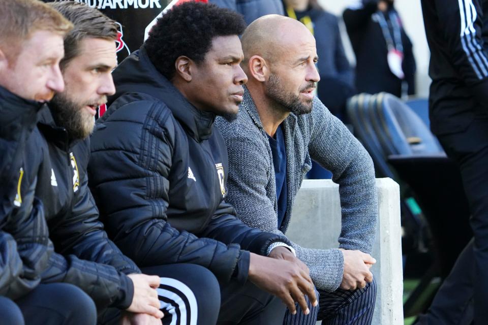 Coulmbus Crew 2 head coach Laurent Courtois (right) watches from the bench.