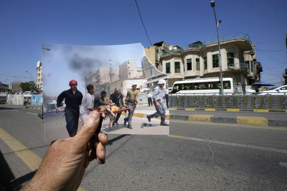 A photograph of Iraqi firemen evacuating an injured person after a car bomb exploded in a commercial neighborhood of central Baghdad, Iraq, Saturday, May 7, 2005, iis inserted into the scene at the same location Friday, March 10, 2023. 20 years after the U.S. led invasion on Iraq and subsequent war. (AP Photo/Hadi Mizban)