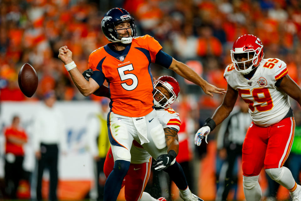 DENVER, CO - OCTOBER 17:  Linebacker Anthony Hitchens #53 of the Kansas City Chiefs strips the ball away from quarterback Joe Flacco #5 of the Denver Broncos as linebacker Reggie Ragland #59 runs to recover the ball during the second quarter at Empower Field at Mile High on October 17, 2019 in Denver, Colorado. (Photo by Justin Edmonds/Getty Images)