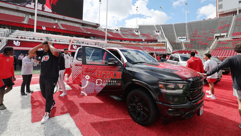 Utah Utes football players look over trucks given to them from the Crimson Collective at Rice-Eccles Stadium in Salt Lake City on Wednesday, Oct. 4, 2023.