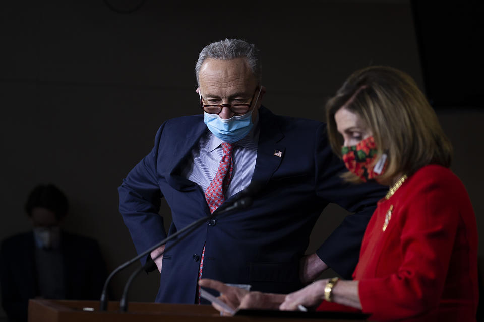 WASHINGTON, DC - DECEMBER 20: Senate Minority Leader Chuck Schumer (D-NY) listens as Speaker of the House Nancy Pelosi (D-CA) speaks during a press conference on Capitol Hill on December 20, 2020 in Washington, DC. Republicans and Democrats in the Senate finally came to an agreement on the coronavirus relief bill and a vote is expected on Monday. (Photo by Tasos Katopodis/Getty Images)