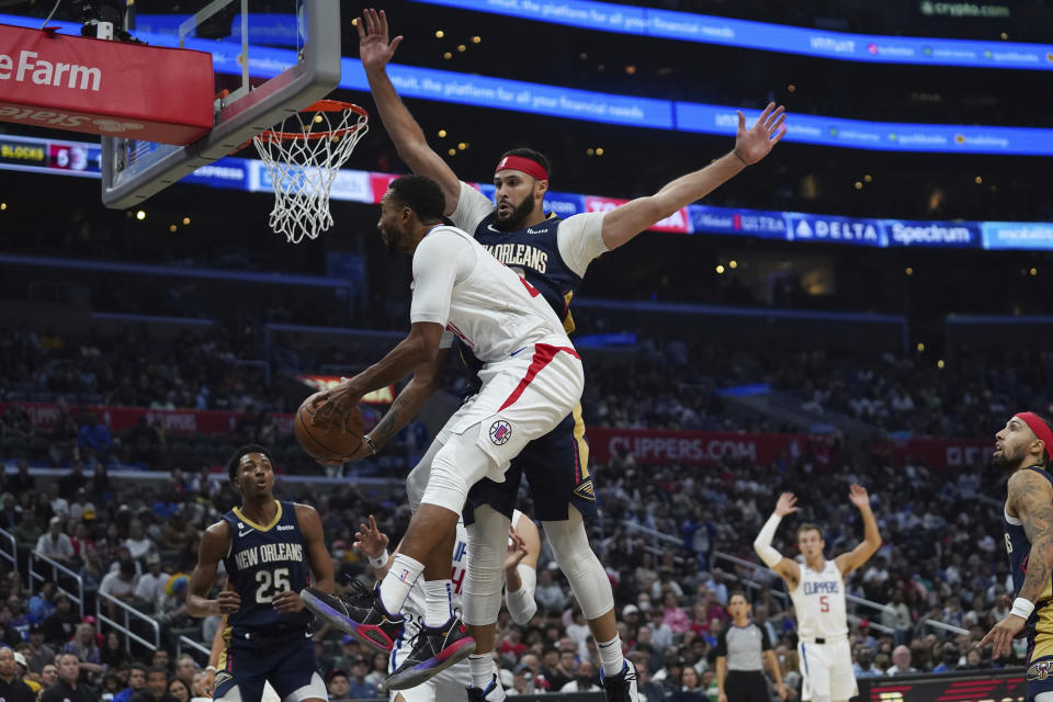 New Orleans Pelicans forward Larry Nance Jr., center right, tries to block a shot by Los Angeles Clippers forward Norman Powell, center left, during the second half of an NBA basketball game on Sunday, Oct. 30, 2022, in Los Angeles. (AP Photo/Allison Dinner)