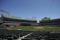 The grounds crew works on the field at Oakland Coliseum before an Oakland Athletics baseball practice in Oakland, Calif., Saturday, July 4, 2020. (AP Photo/Jeff Chiu)