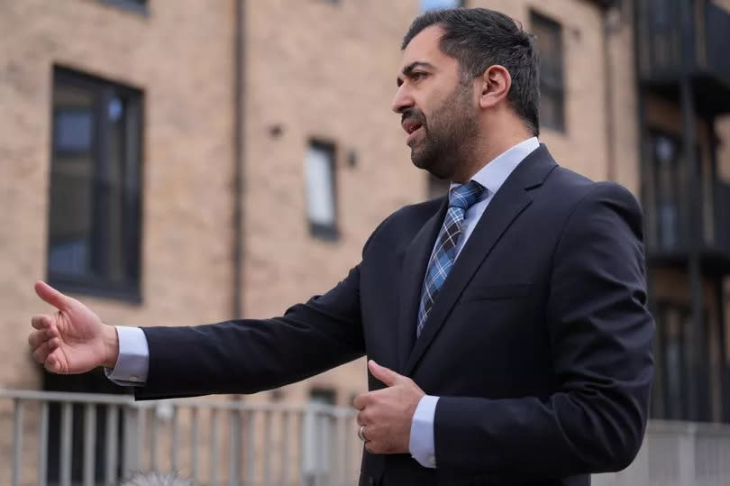 First Minister Humza Yousaf speaking to the media during a visit to a housing development in Dundee