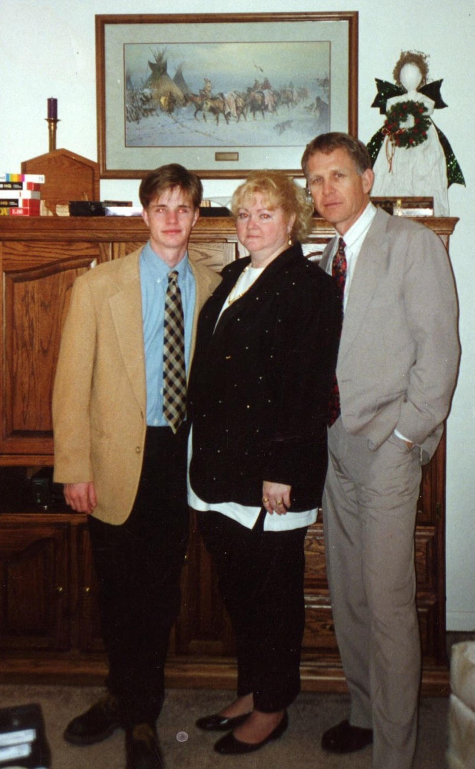 This undated photo provided by the Matthew Shepard Foundation, shows Matthew Shepard, left, with his parents, Judy and Dennis Shepard. The murder of Shepard, a gay University of Wyoming student, was a watershed moment for gay rights and LGBTQ acceptance in the U.S., so much so that 20 years later the crime remains seared into the national consciousness. (The Matthew Shepard Foundation via AP)