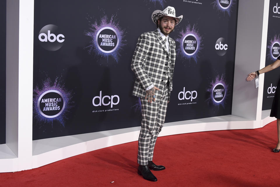 Post Malone arrives at the American Music Awards on Sunday, Nov. 24, 2019, at the Microsoft Theater in Los Angeles. (Photo by Jordan Strauss/Invision/AP)