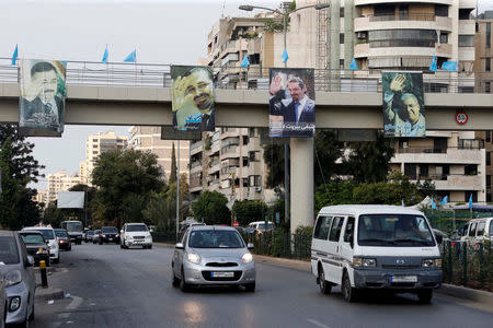 Pictures hung on a pedestrian bridge show (L to R) intelligence officer Wissam al-Hassan, Lebanon's former prime minister Saad al-Hariri (2 pictures) and Lebanon's Interior Minister Nohad Machnouk, in Beirut, Lebanon October 25, 2016. Picture taken October 25, 2016. REUTERS/Mohamed Azakir