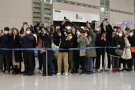 People take photos of South Korean director Bong Joon-ho upon his arrival at the Incheon International Airport in Incheon, South Korea, Sunday, Feb. 16, 2020. South Koreans are reveling in writer-director Bong's dark comic thriller, "Parasite," which won this year's Academy Awards for best film and best international feature. The movie itself, however, doesn't put the country in a particularly positive light. (AP Photo/Ahn Young-joon)