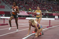 Emma Coburn, of the United States, falls in the final of the women's 3,000-meters steeplechase at the 2020 Summer Olympics, Wednesday, Aug. 4, 2021, in Tokyo. (AP Photo/Matthias Schrader)