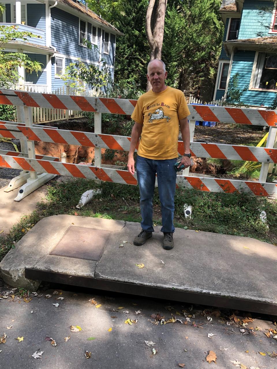 Nat Dickinson, who lives next door to a large sinkhole that's opened up at 271 Montford Ave., says the city's four large street drains in the area channel an enormous amount of water into the culvert that failed.