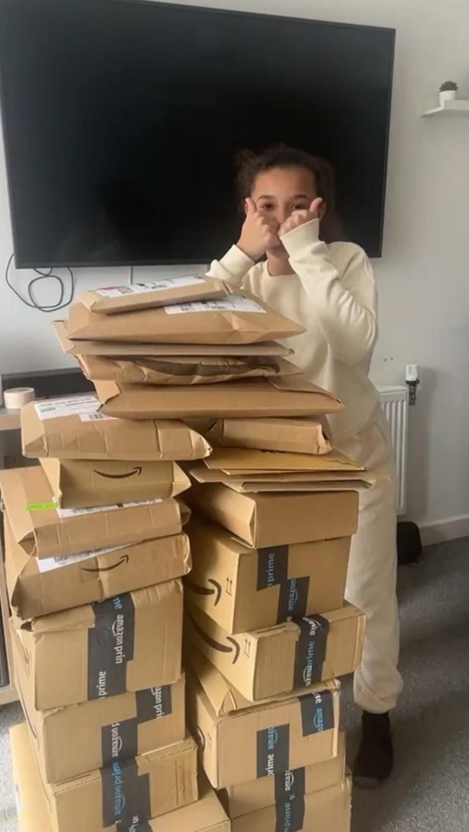 Girl standing resting on pile of parcels 