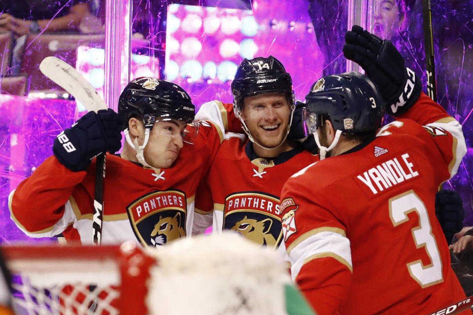 Florida Panthers center Frank Vatrano, left, defenseman Mark Pysyk, center, and Keith Yandle, right, celebrate after Vatrano scored during the second period of the team's NHL hockey game against the Los Angeles Kings, Thursday, Jan. 16, 2020, in Sunrise, Fla. (AP Photo/Brynn Anderson)