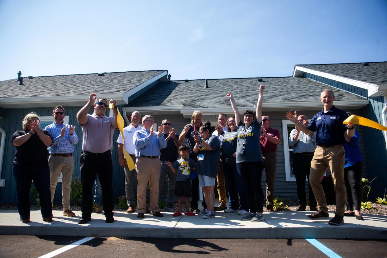 The ribbon is cut on five new affordable homes Wednesday, Aug. 16, 2023, in Holland Township. The five homes offer affordable housing for individuals with disabilities.