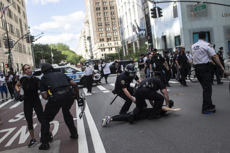 Police detain protesters in front of Trump Tower during a solidarity rally for George Floyd, Saturday, May 30, 2020, in New York. Demonstrators took to the streets of New York City to protest the death of Floyd, a black man who was killed in police custody in Minneapolis on May 25. (AP Photo/Wong Maye-E)