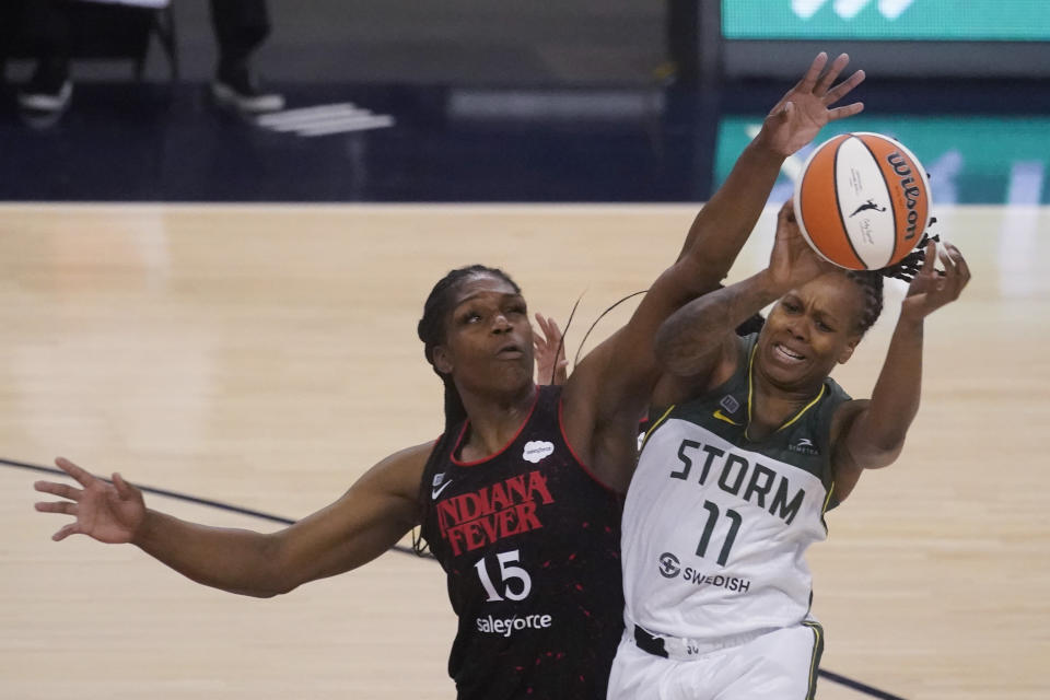 Seattle Storm's Epiphanny Prince passes the ball as Indiana Fever's Teaira McCowan defends during the second half of a WNBA basketball game Thursday, June 17, 2021, in Indianapolis. (AP Photo/Darron Cummings)