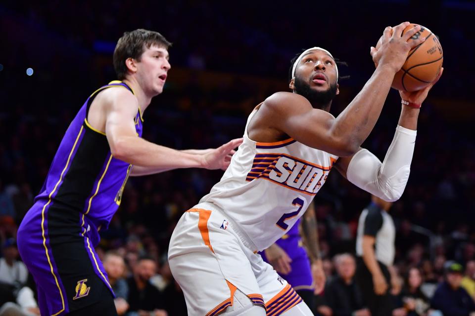 Phoenix Suns forward Josh Okogie (2) moves to the basket against Los Angeles Lakers guard Austin Reaves (15) during the first half at Crypto.com Arena.