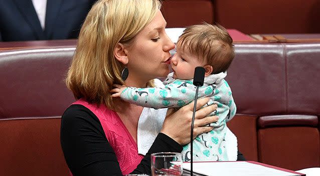 Australian Greens Senator Larissa Waters kisses her daughter Alia Joy after putting forward a motion. Source: AAP Image/Lukas Coch