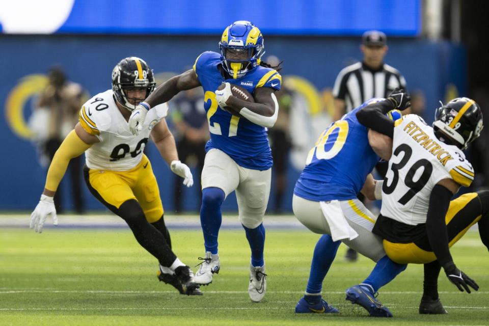 The Rams' Darrell Henderson Jr. (27) finds a running lane against the Steelers.