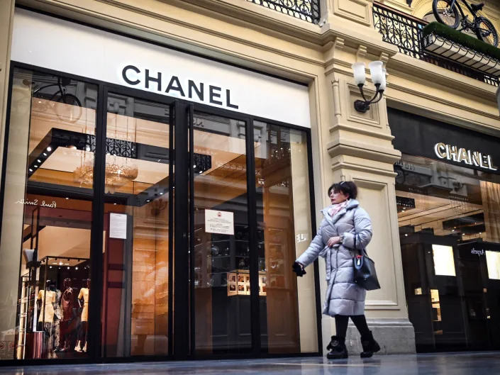 A woman walks past a closed Chanel shop in Moscow on March 10, 2022