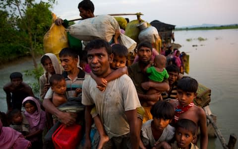 Rohingya Muslims crossing the border from Myanmar into Bangladesh in 2017 after a brutal military crackdown - Credit: AP Photo/Bernat Armangue, File