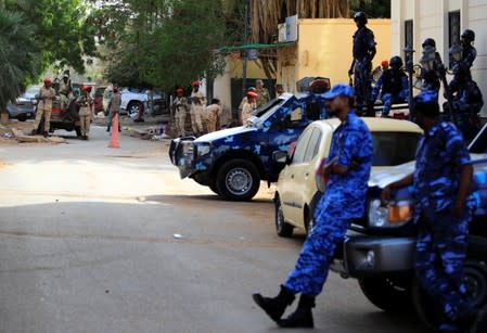 Sudanese soldiers secure the area as Sudan's ex-president Omar al-Bashir leaves the office of the anti-corruption prosecutor in Khartoum