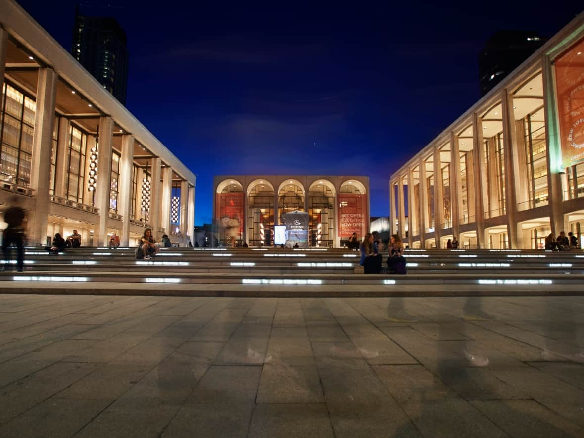 Lincoln Center for the Performing Arts is shown in New York City. David Geffen Hall, home to the New York Philharmonic, is shown on the right, before undergoing a $550-million US renovation undertaken by a Canadian architecture firm. The concert hall reopened in October. (Carlo Allegri/Reuters - image credit)