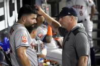 Houston Astros starting pitcher Jose Urquidy listens to pitching coach Joshua Miller after the sixth inning of the team's baseball game against the Chicago White Sox on Monday, Aug. 15, 2022, in Chicago. (AP Photo/Charles Rex Arbogast)