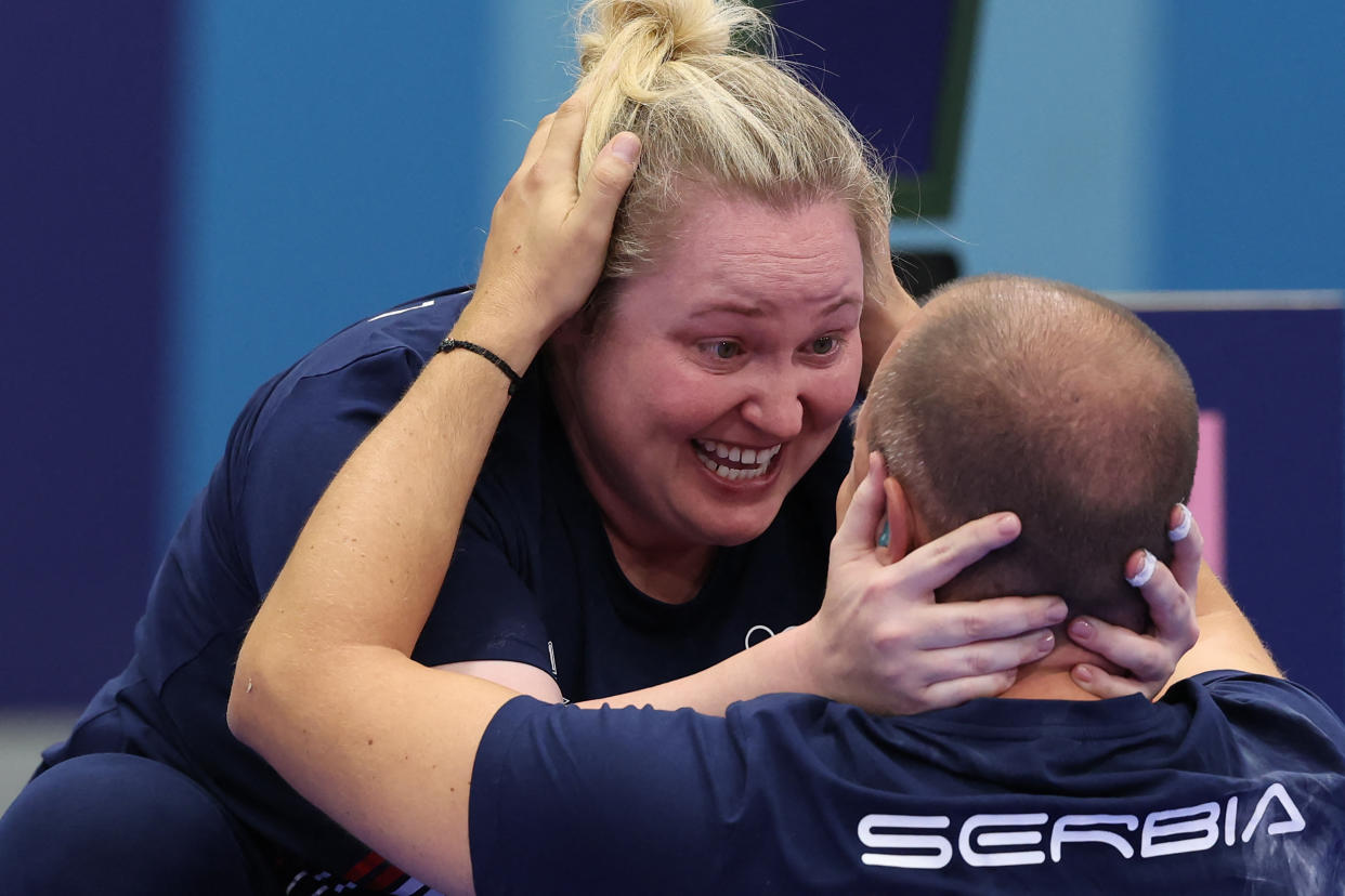 Serbia's Zorana Arunovic and Serbia's Mikec Damir celebrate after winning the shooting 10m air pistol mixed team gold medal match during the Paris 2024 Olympic Games at Chateauroux Shooting Centre on July 30, 2024. (Photo by ALAIN JOCARD / AFP)