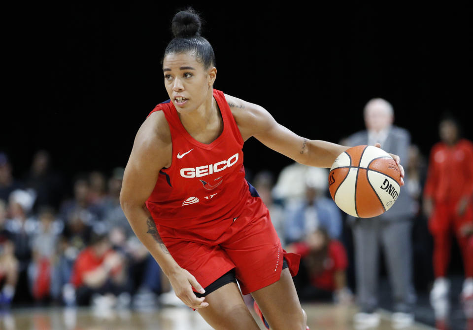 FILE - In this Sept. 24, 2019 file photo, Washington Mystics' Natasha Cloud drives up the court against the Las Vegas Aces during the second half of Game 4 of a WNBA playoff basketball in Las Vegas. Cloud and her WNBA colleagues continue to be active in the fight against social injustice and police brutality, participating in protests and continuing work that they began four years ago. (AP Photo/John Locher, File)