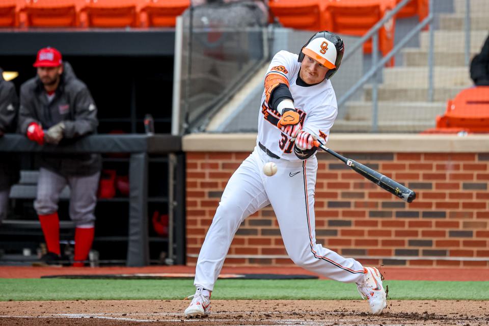 Oklahoma State's David Mendham hits a ground ball during the Cowboys' game against Loyola Marymount at O’Brate Stadium in Stillwater on Saturday.