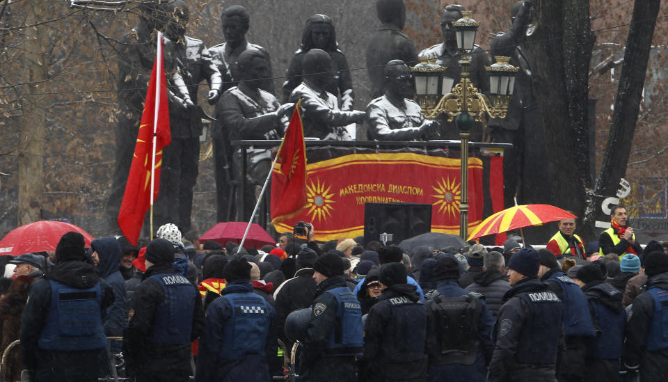 Police stand guard during a protest against the change of the country's name outside the parliament building in Skopje, Macedonia, Wednesday, Jan. 9, 2019. Macedonian lawmakers are entering the last phase of debate on constitutional changes to rename their country North Macedonia as part of a deal with neighboring Greece to pave the way for NATO membership and eventually joining the European Union. (AP Photo/Boris Grdanoski)