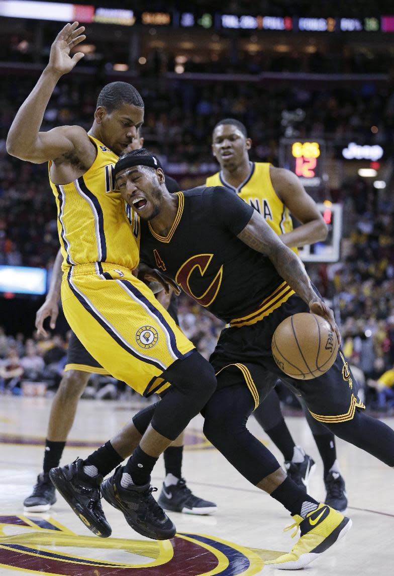 Cleveland Cavaliers' Iman Shumpert, right, is fouled by Indiana Pacers' Glenn Robinson III in the first half of an NBA basketball game, Wednesday, Feb. 15, 2017, in Cleveland. (AP Photo/Tony Dejak)