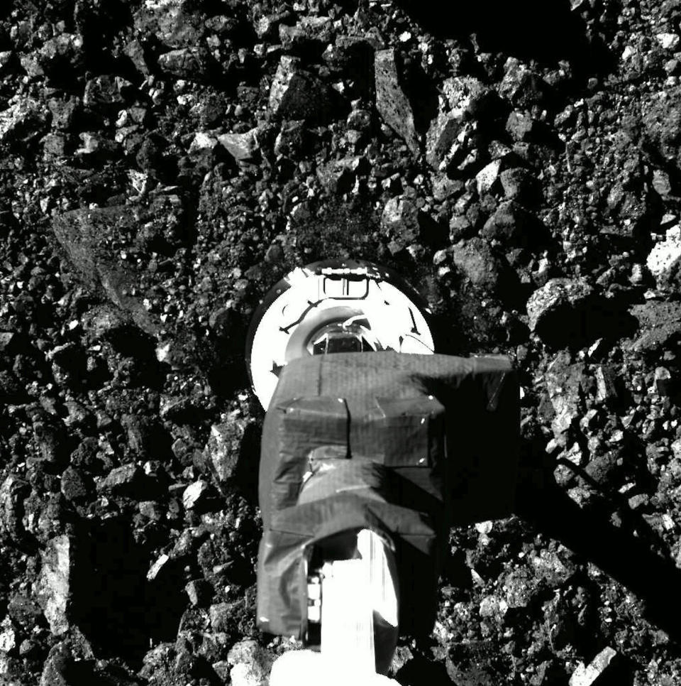 The moment of truth: the OSIRIS-REx sample acquisition mechanism plunges into the surface of the asteroid Bennu on Oct. 20, 2020, collecting about a half-pound of rocks and dust for return to Earth. / Credit: NASA