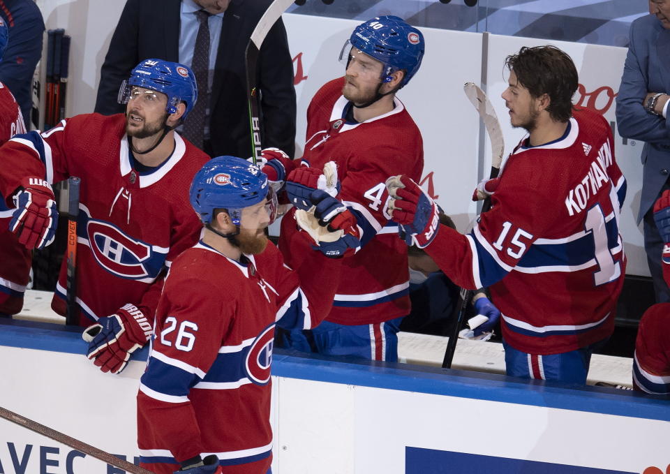 Montreal Canadiens defenseman Jeff Petry (26) is congratulated by teammates Tomas Tatar (90), Joel Armia (40) and Jesperi Kotkaniemi (15) after scoring against the Pittsburgh Penguins during the third period of an NHL hockey playoff game Wednesday, Aug. 5, 2020 in Toronto. (Frank Gunn/The Canadian Press via AP)