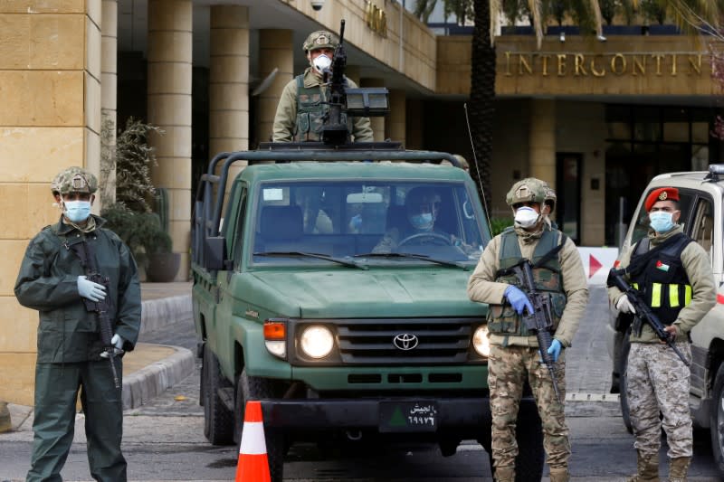 FILE PHOTO: Jordanian army members guard outside a hotel that was transformed into a quarantine station in Amman