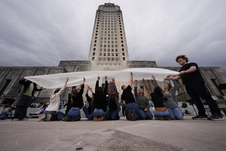 Benjamin Franklin High playwriting class students perform their play "The Capitol Project" on the steps of the Louisiana Capitol in Baton Rouge, La., Wednesday, March 27, 2024. (AP Photo/Gerald Herbert)