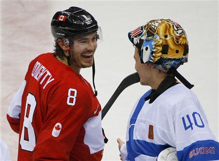 Canada's Drew Doughty laughs with Finland's goalie Tuukka Rask after Canada defeated Finland in overtime in their men's preliminary round ice hockey game at the 2014 Sochi Winter Olympics, February 16, 2014. REUTERS/Brian Snyder