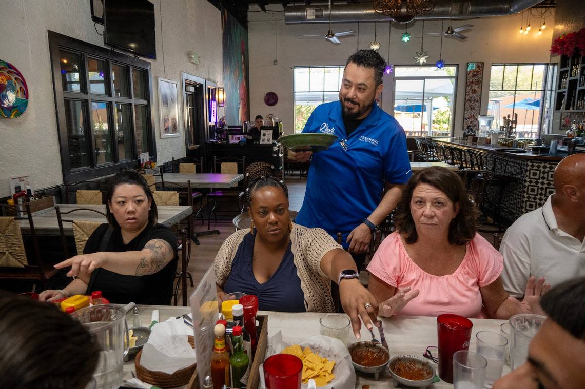 Bartender John Tinoco serves dinner plates during a wedding party at Q’bole Cocina & Cantina in Folsom on Thursday.