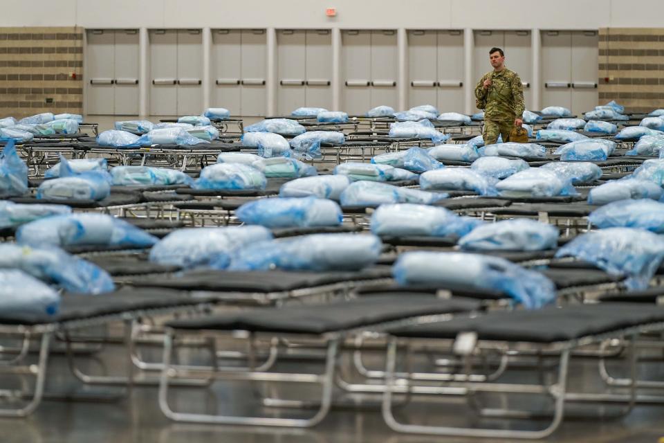 Members of the Texas Army National Guard set up a field hospital in response to the new coronavirus crisis at the Kay Bailey Hutchison Convention Center on Tuesday, March 31, 2020, in Dallas. (Smiley N. Pool/The Dallas Morning News via AP, Pool)